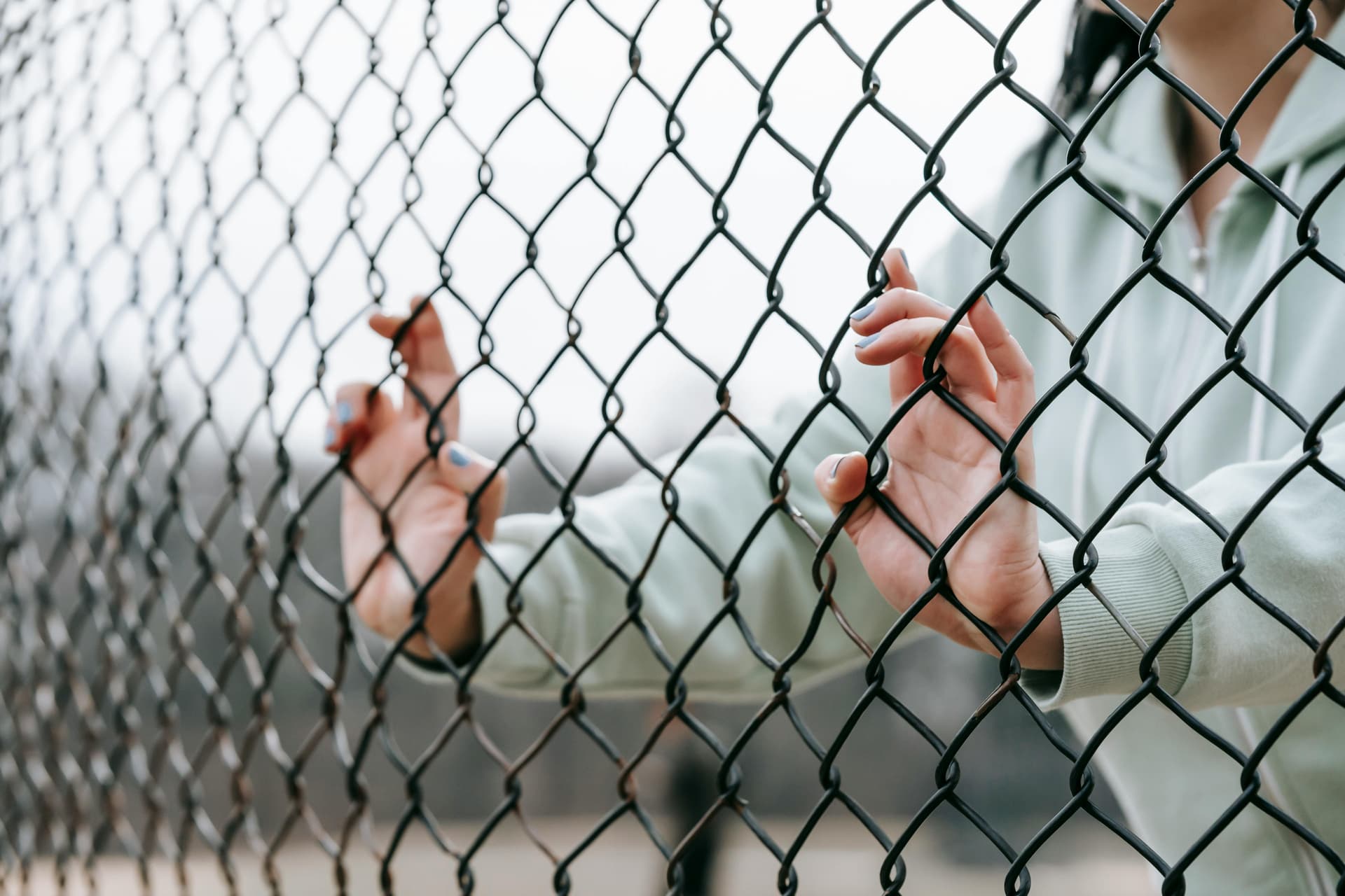 Woman behind fence